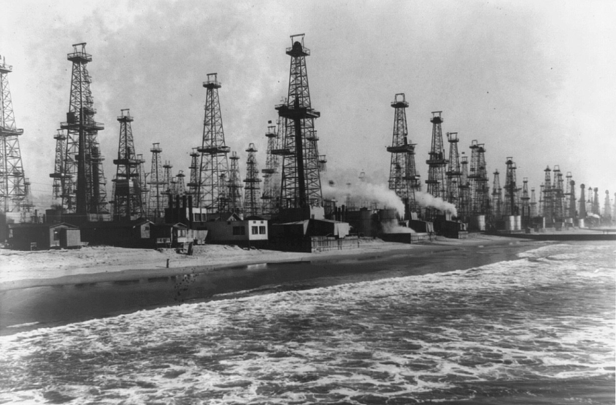 Dozens of oil derricks lining the shore and piers at Summerland, California.